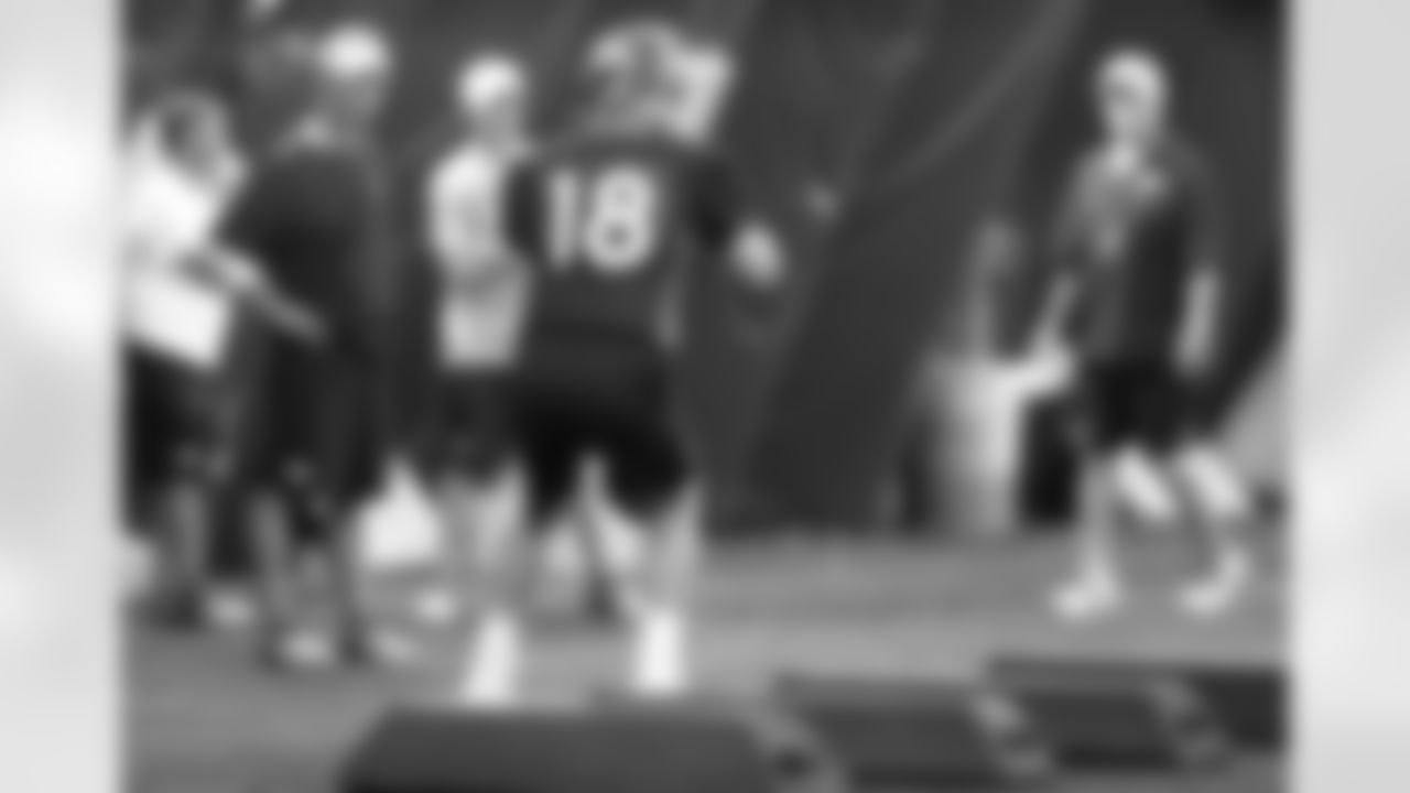 Head Coach John Fox and Offensive Coordinator Mike McCoy watch QB Peyton Manning run through a drill.