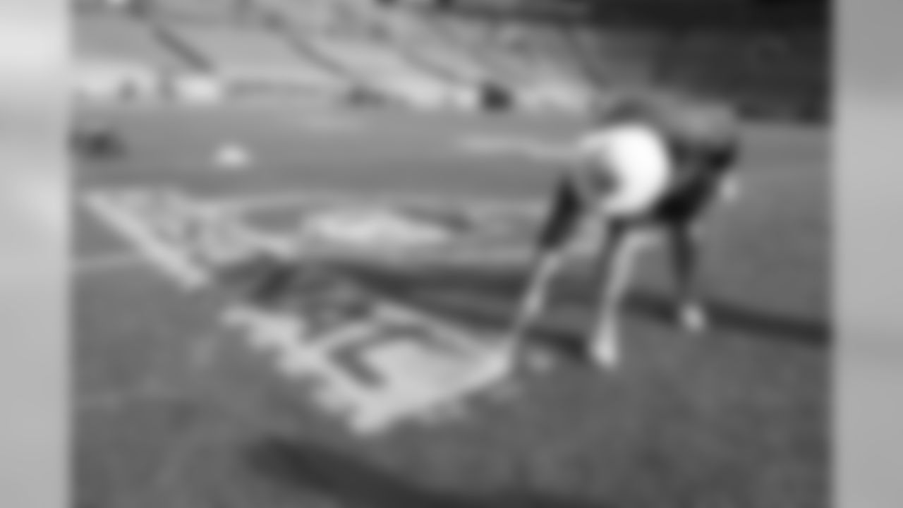 The grounds crew gets the field ready for Saturday's Divsional Round game.