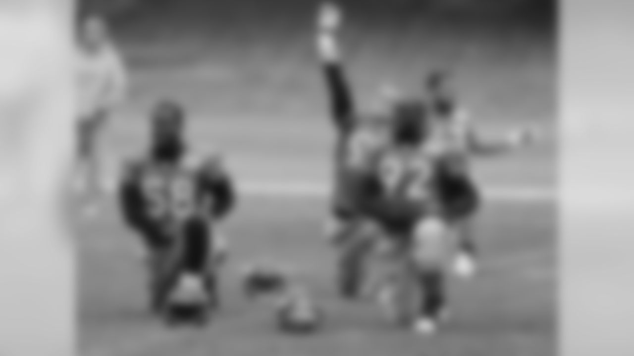 LB Von Miller and DE Elvis Dumervil stretch together.