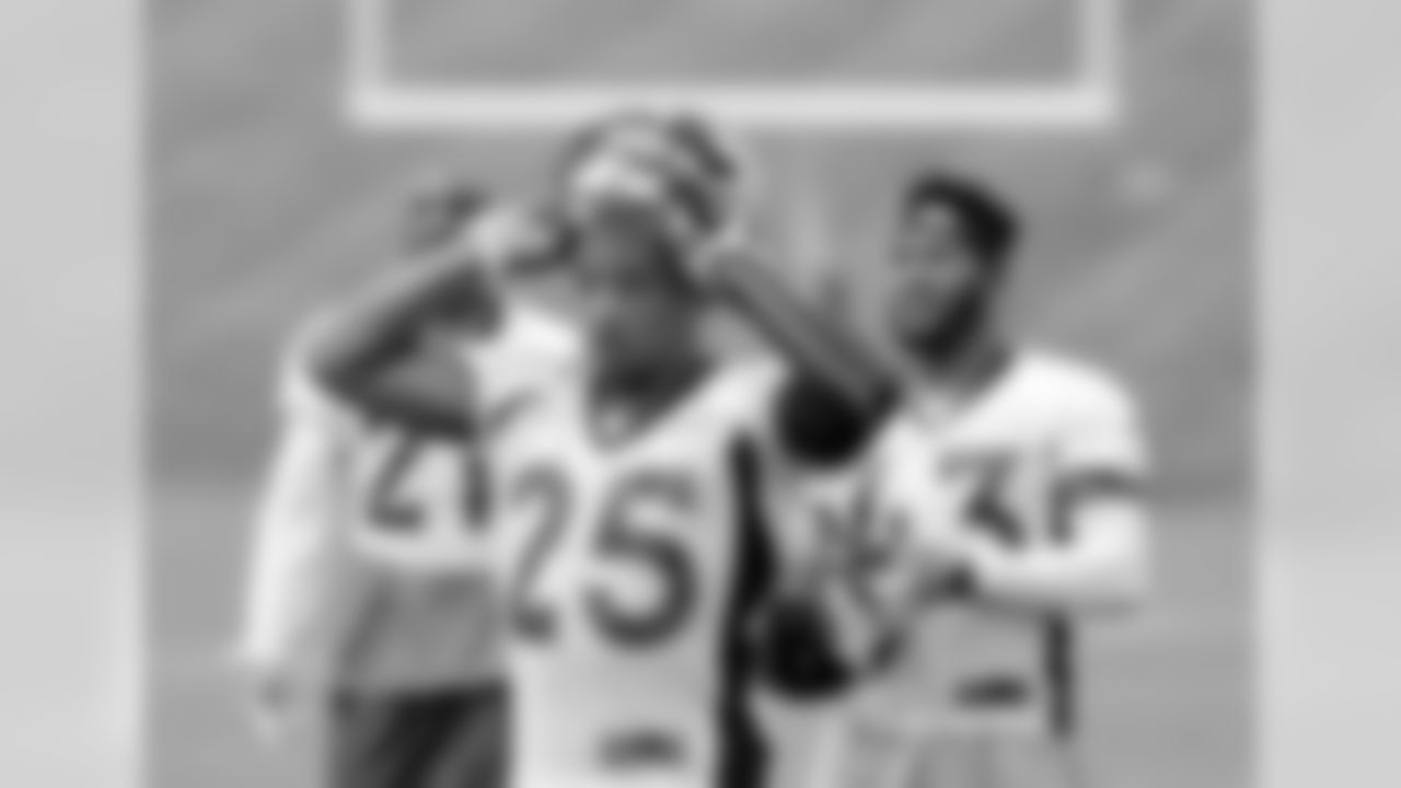 Chris Harris takes his helmet off for a short break during OTAs on Wednesday.