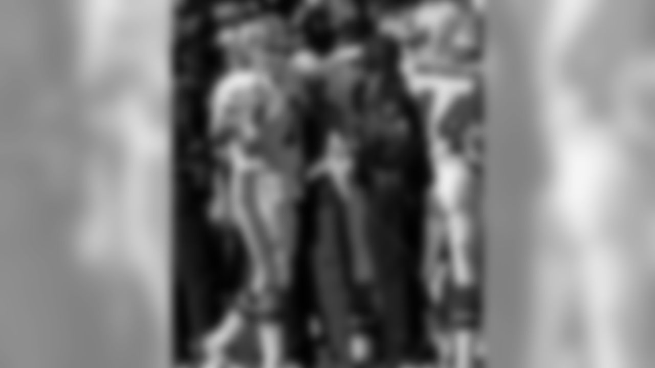 Oakland Raiders vs. Denver Broncos at Oakland Alameda County Coliseum Sunday, December 24, 1995. The Broncos beat the Raiders 31-28. Denver Broncos quarterback John Elway (7) shakes hands with head coach Mike Shanahan. (AP Photo/Al Golub)
