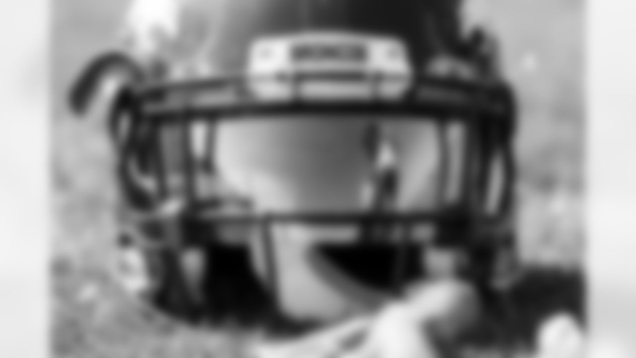 Melvin Gordon III is seen in a reflection off his helmet's visor during practice at UCHealth Training Center on September 6, 2021. (Photo by Ben Swanson)