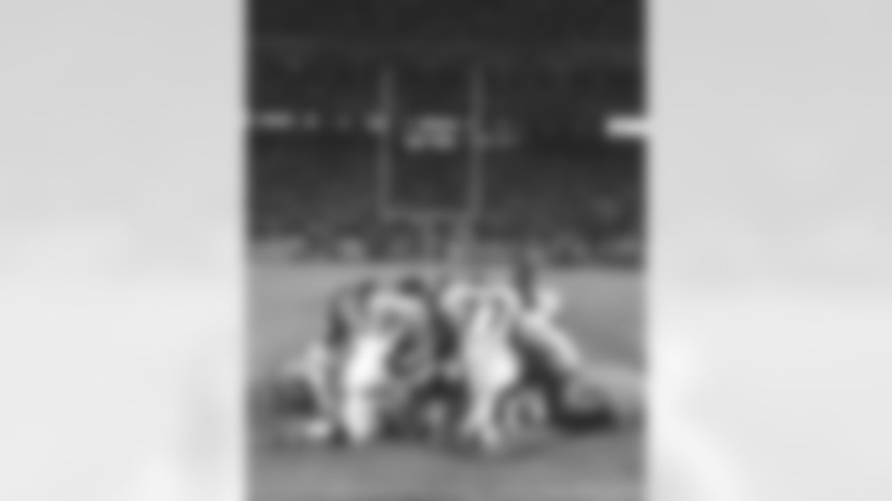 Kansas City: Tony Jones along with other Broncos and Chiefs players huddle at midfield for a prayer after the Broncos victory against the Kansas City Chiefs at Arrowhead Stadium in Kansas City, MO on January 4, 1998.