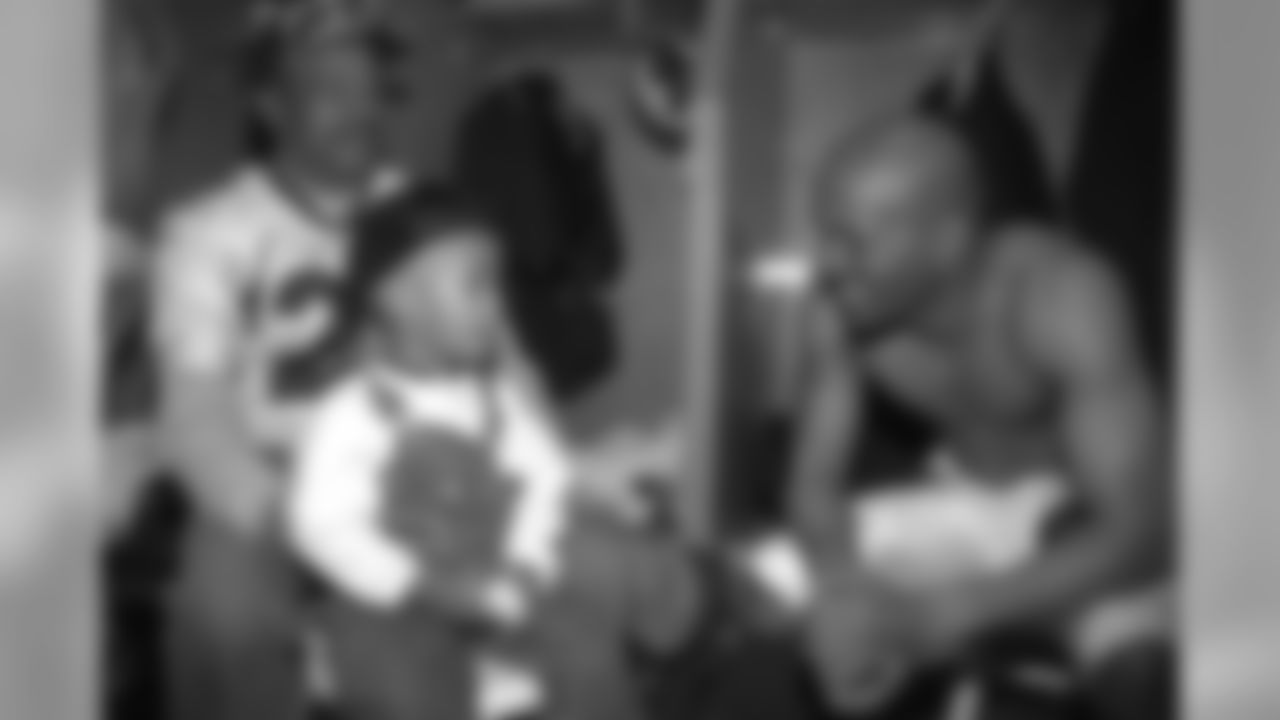 San Diego: Randy Hilliard relaxes in the locker room with family members during the postgame celebration against the Green Bay Packers at Qualcomm Stadium in San Diego, CA on January 25, 1998.