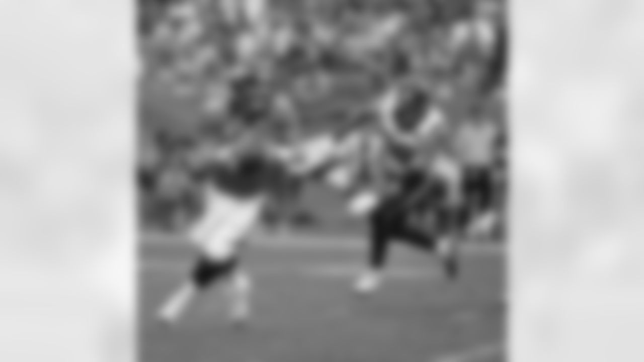 QB Peyton Manning rolls out away from LB Connor Barwin.