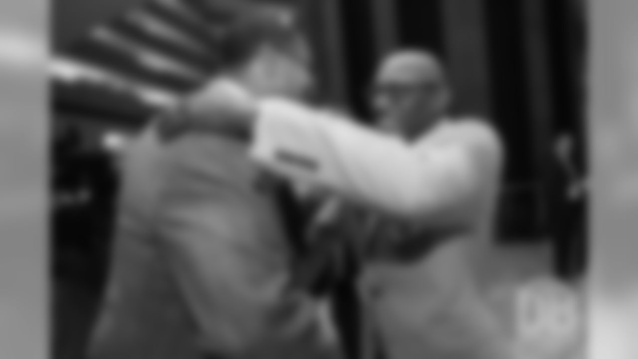 Floyd Little hugs Steve Atwater at the Pro Football Hall of Fame's Merlin Olsen Luncheon in Atlanta on February 1, 2019.