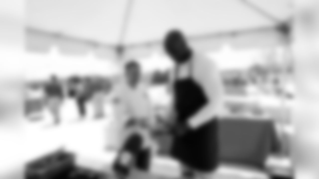 OLB DeMarcus Ware assisted chef Troy Guard in preparing Thai chicken sliders.