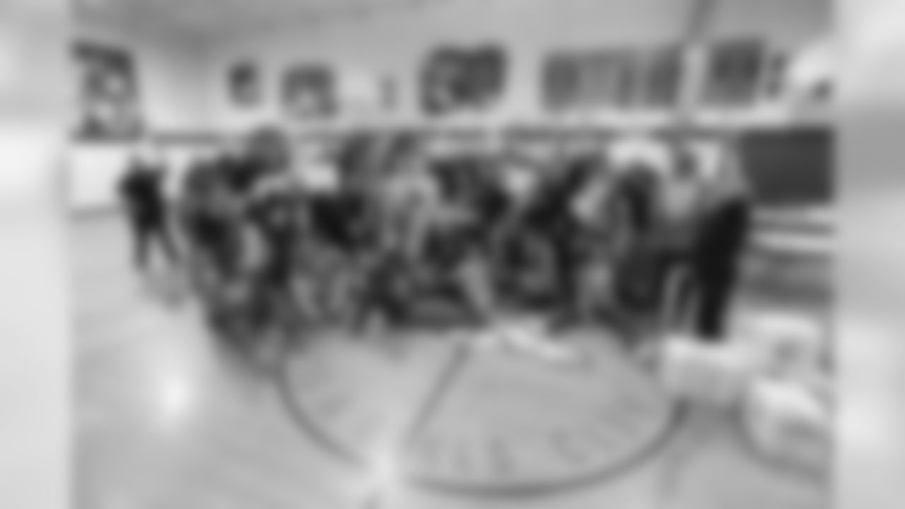 A group photo of all the participants during a meal-packaging event with Feeding Children Everywhere at the Denver Broncos Boys & Girls Club on May 14, 2019, with volunteers from the Broncos, the Denver Police Department and the club.