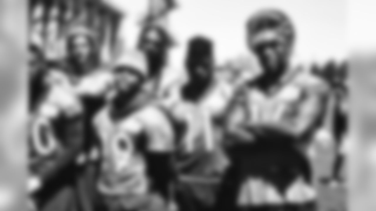 Bennie Fowler and members of the wide receiver corps after minicamp practice.