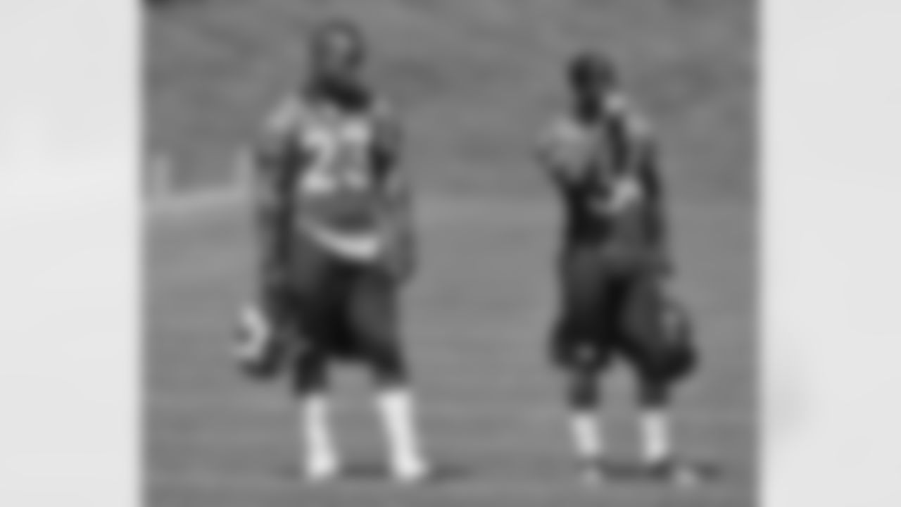RBs Willis McGahee and Ronnie Hillman talk during practice.