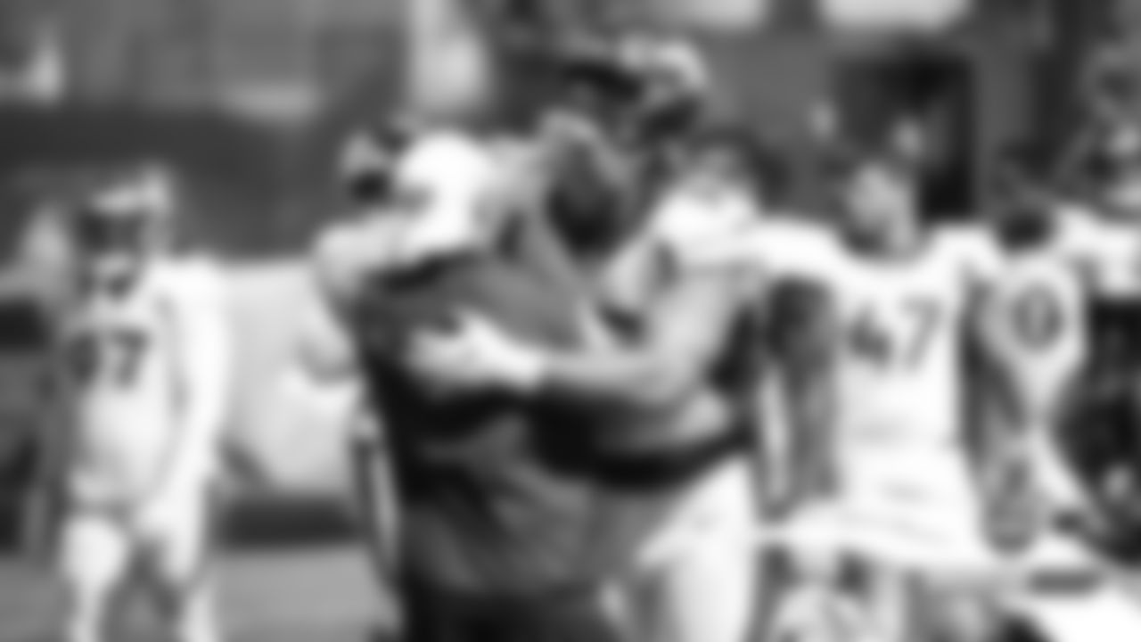 Derek Wolfe greets former teammate Wes Welker, who is now the 49ers' wide receivers coach, at a joint practice with the San Francisco 49ers on the 20th day of training camp on August 17, 2019.