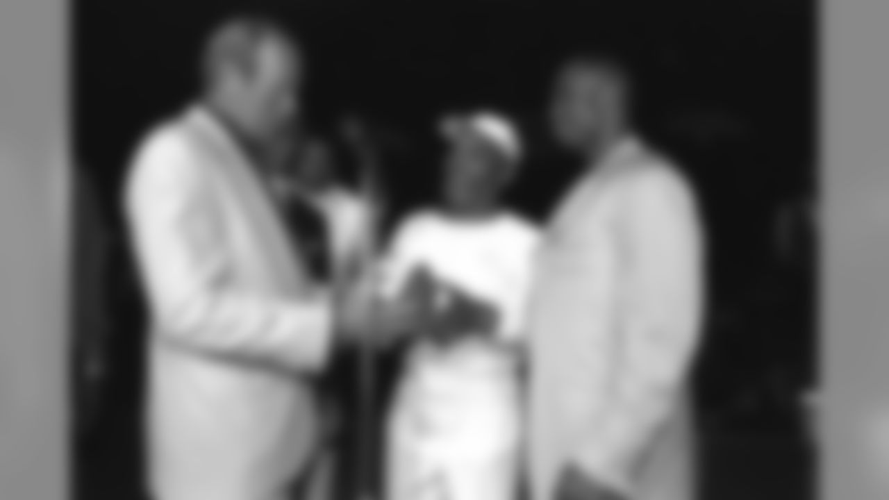 The players and coaches of the Denver Broncos were presented their second consecutive Super Bowl rings during a ceremony held at the Broadmoor Hotel in Colorado Springs. Here, team owner Pat Bowlen receives a commemorative football from Ray Crockett (right) and other players.