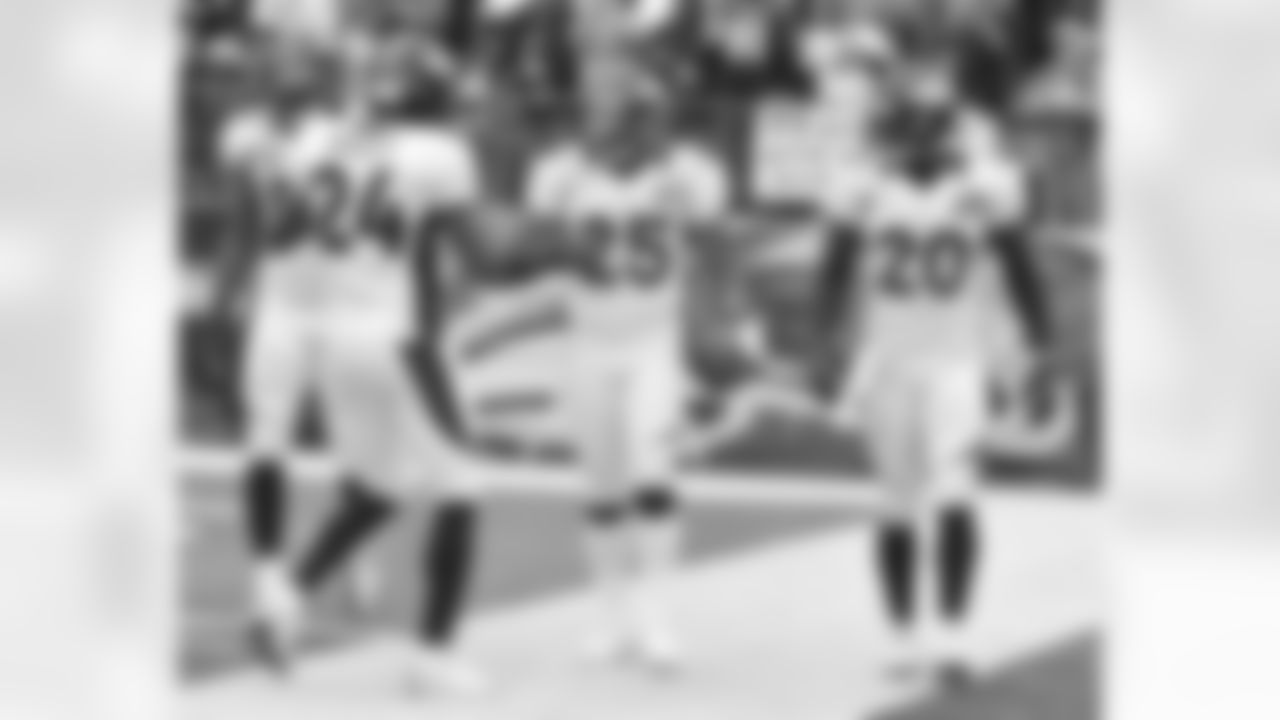Harris celebrates the pick-six with his fellow defensive backs.