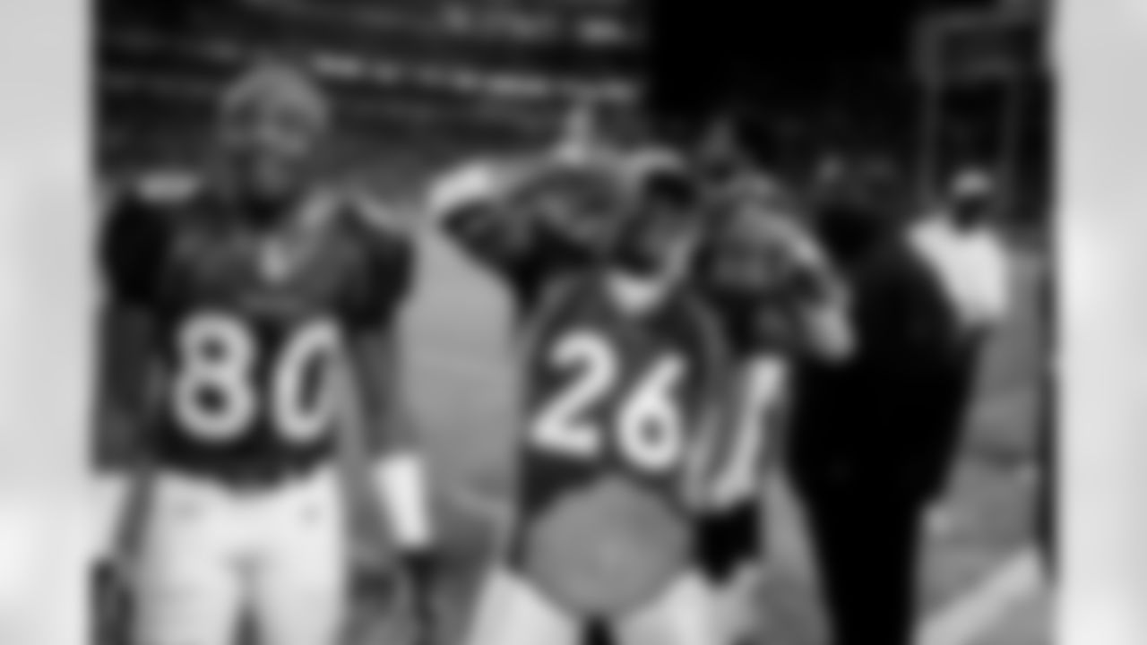 Clinton Portis wears a heavyweight champion belt and acknowledges the fans cheers after his career day against the Kansas City Chiefs at Invesco Field at Mile High in Denver, CO on December 7, 2003.