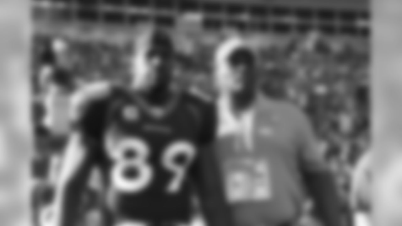 Former Bronco Tom Graham stands next to his son, Daniel, who is a tight end for the Broncos, before a 2008 game against Miami.