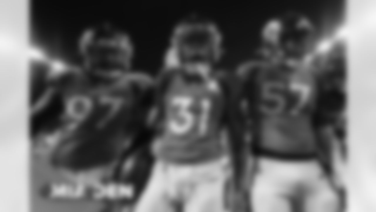 Justin Simmons, Jeremiah Attaochu and DeMarcus Walker celebrate after Simmons' game-sealing interception the Broncos' Week 11 game against the Miami Dolphins at Empower Field at Mile High in Denver, Colorado on November 22, 2020. (Photo by Gabriel Christus)