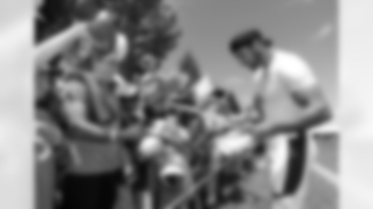 Decker signs autographs after practice.