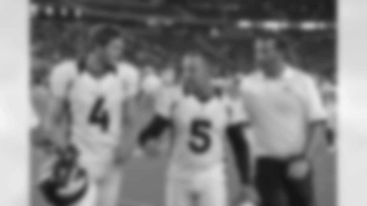 Kicker Matt Prater walks off the field with punter Britton Colquitt and Special Teams Coach Jeff Rodgers.