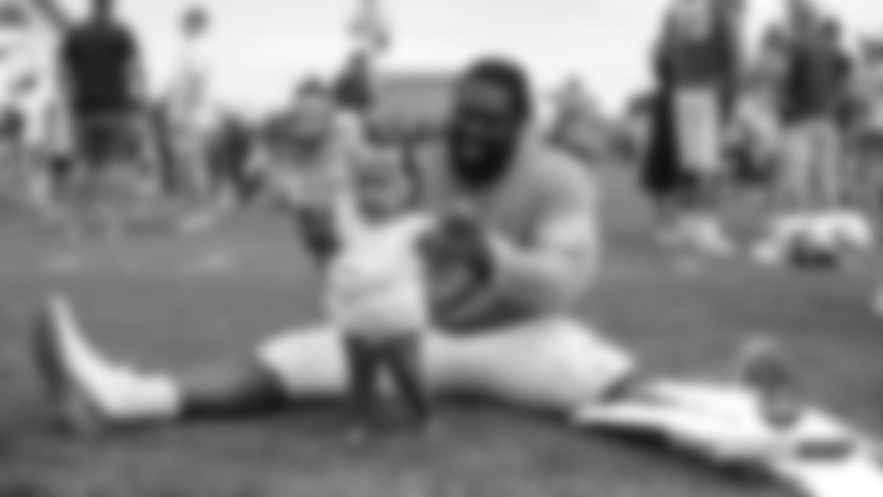 Shelby Harris holds up his daughter, Evelyn, at a joint practice with the San Francisco 49ers on the 20th day of training camp on August 17, 2019.