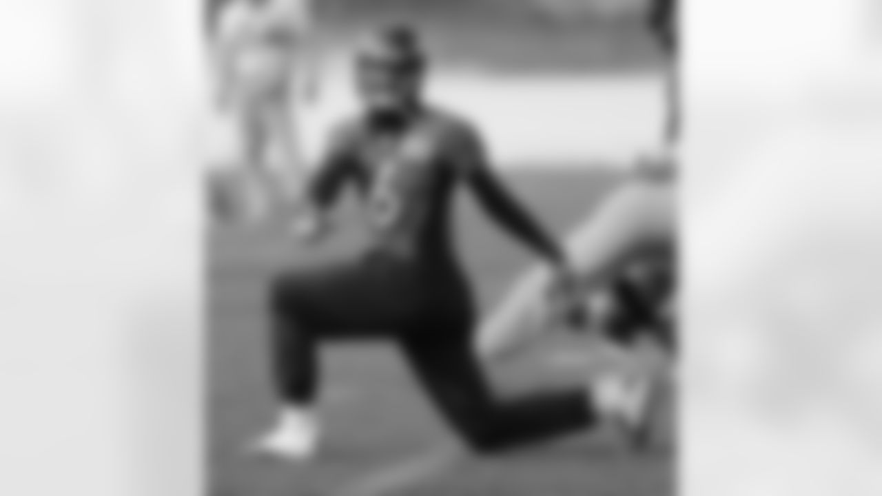 QB Brock Osweiler stretches before practice.