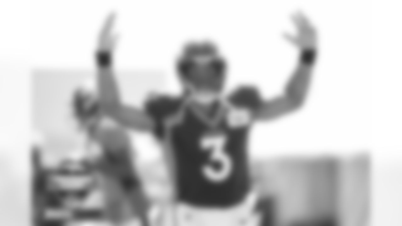 Russell Wilson hypes the crowd up at practice on Day 6 of training camp at UCHealth Training Center in Englewood, Colorado on August 2, 2022. (Photo by Ben Swanson)