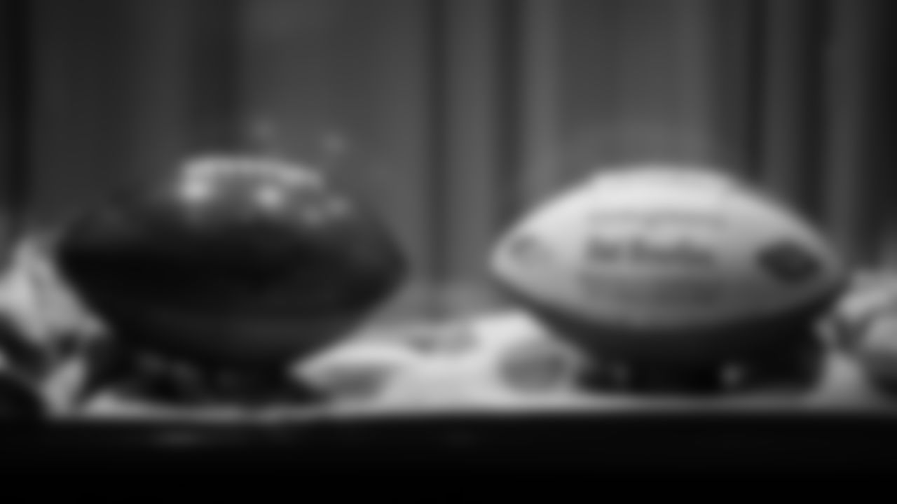 A wooden football commemorating the Broncos' Super Bowl XXXII win and Mr. Bowlen's game ball for that victory are featured in a display at the open-house tribute to Pat Bowlen at Broncos Stadium at Mile High on June 18, 2019.