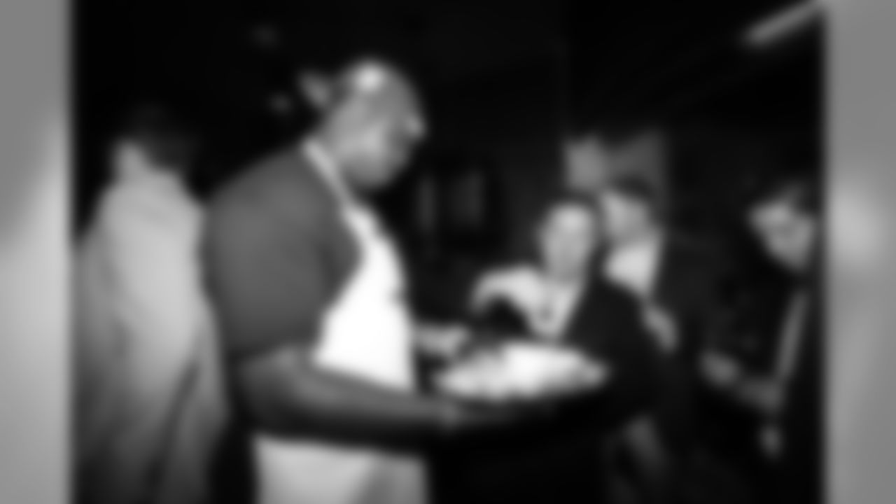 Denver Broncos defensive end Malik Jackson makes his rounds through the crowd with a plate of shrimp and cocktail sauce.
