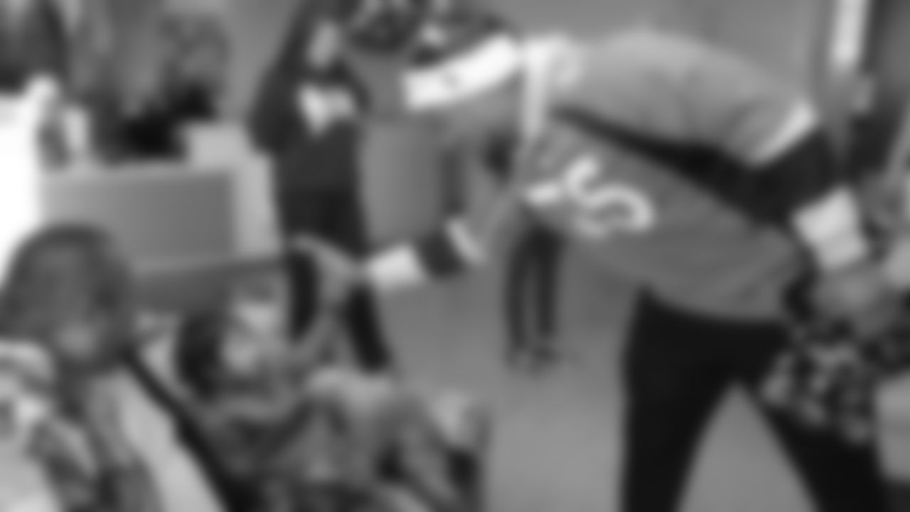 Bradley Chubb high-fives a patient during a Build-A-Bear distribution at Children's Hospital Colorado in Aurora on December 17, 2018.