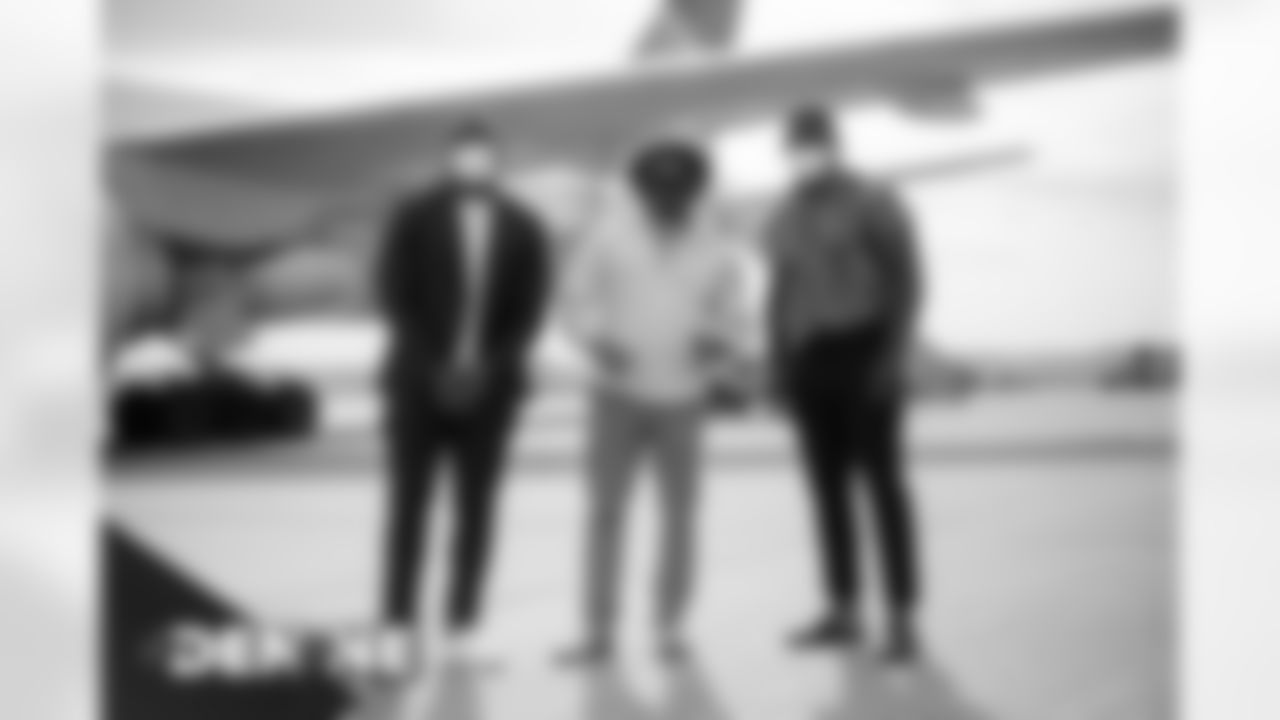 Royce Freeman, Phillip Lindsay and Jeremy Cox on the tarmac at Denver International Airport on October 17, 2020 during the team's travel to New England for a Week 6 game against the Patriots. (Photo by Ben Swanson)
