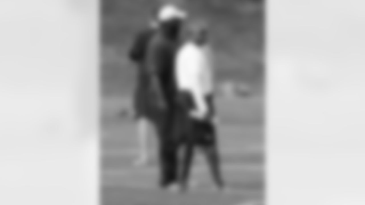 Secondary Coach Ron Milus talks with Assistant Secondary Coach Sam Garnes before practice.