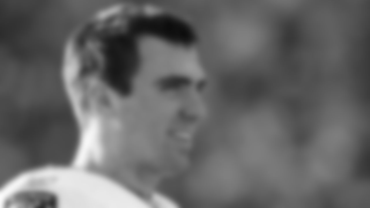 Joe Flacco smiles on the sidelines during a game against the Carolina Panthers on Nov. 21, 2010. (AP Photo/Chuck Burton)