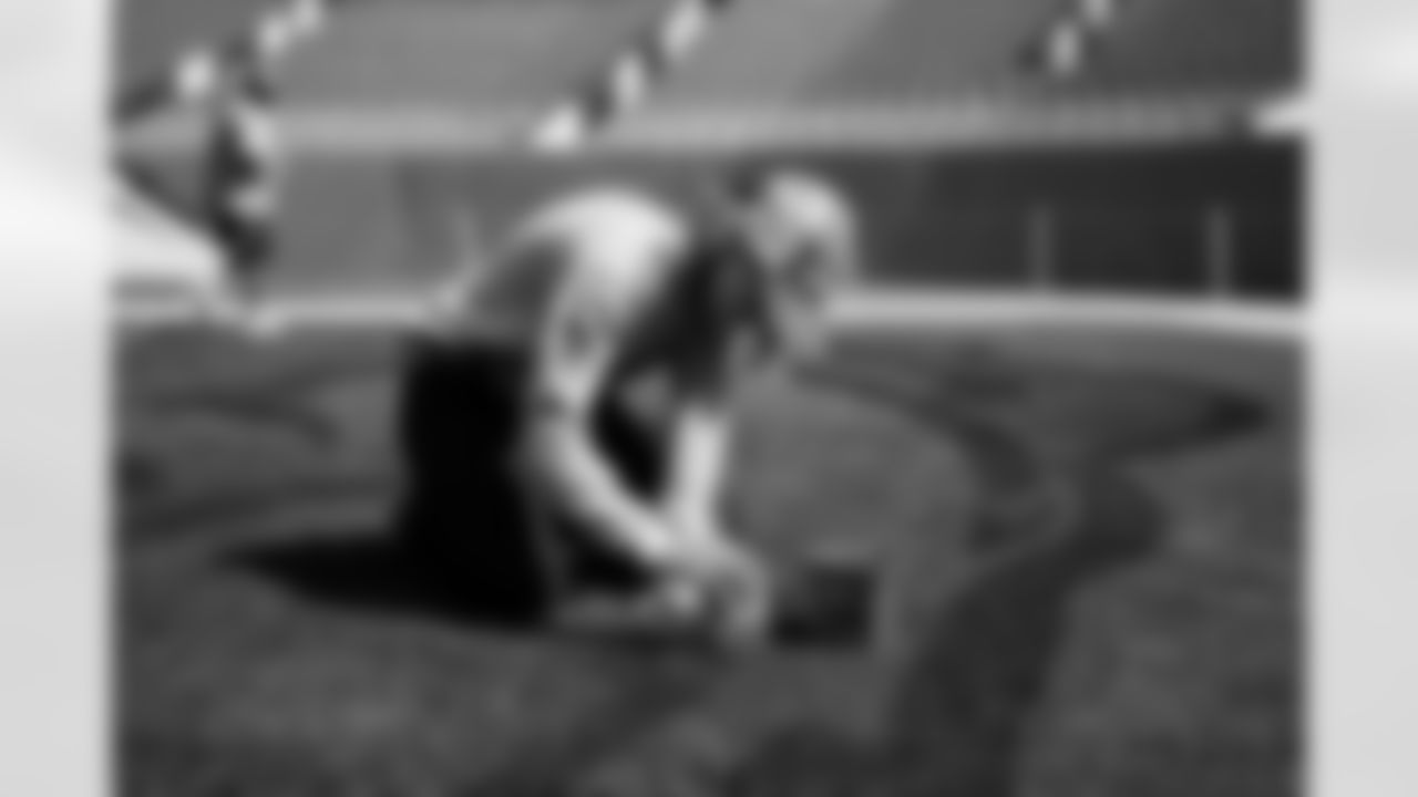 Members of the stadium's turf crew paint the field at Empower Field at Mile High on September 23, 2021 ahead of the team's Week 3 home opener. (Photo by Ben Swanson)