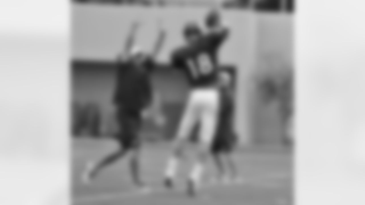 QB Peyton Manning throws a pass over QB Coach Adam Gase.
