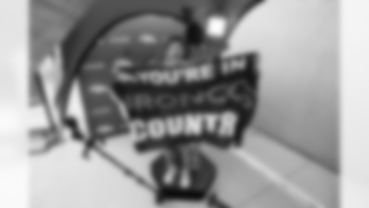 Two fans make a hype video/GIF at UCHealth's station at the Back Together Saturday event celebrating the return of fans to training camp at UCHealth Training Center on July 31, 2021. (Photo by Ben Swanson)
