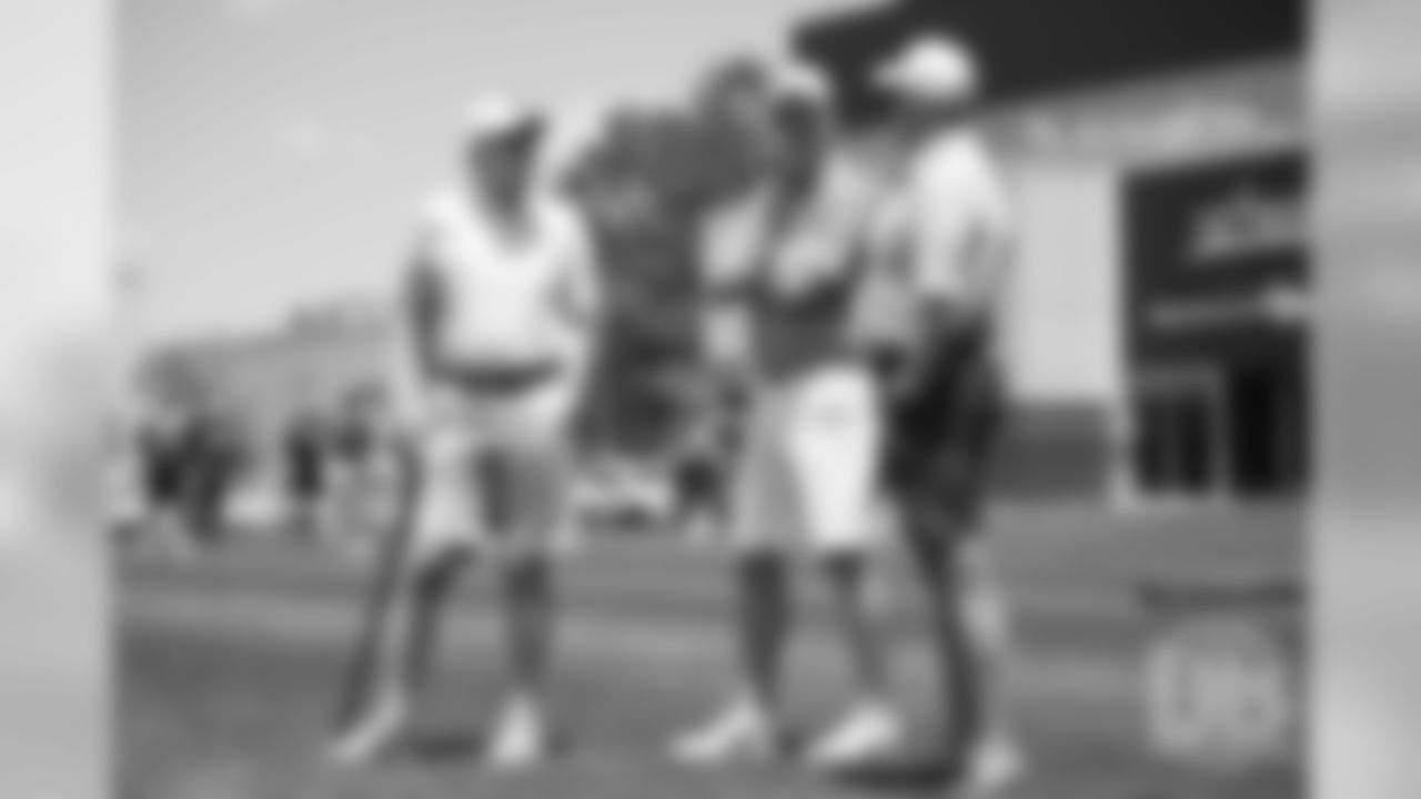 Archie and Peyton Manning talk with President of Football Operations/General Manager John Elway during the Broncos' second mandatory minicamp practice on June 5, 2019.