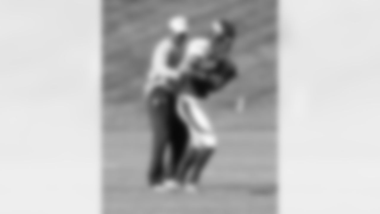 Decker holds onto the ball, despite pressure from WR Coach Tyke Tolbert.