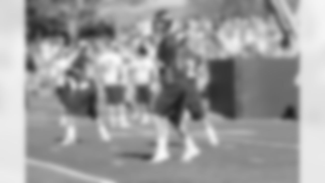 QB Peyton Manning warms up before practice.
