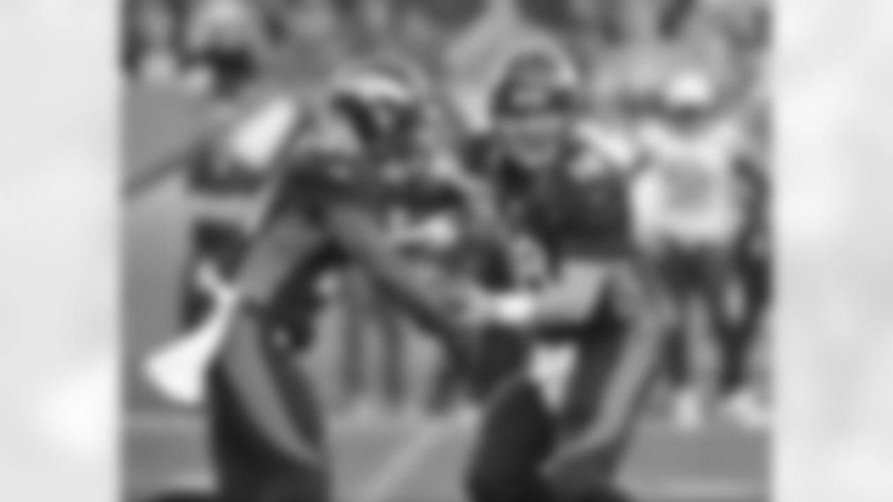 Manning hands the ball to RB Ronnie Hillman.
