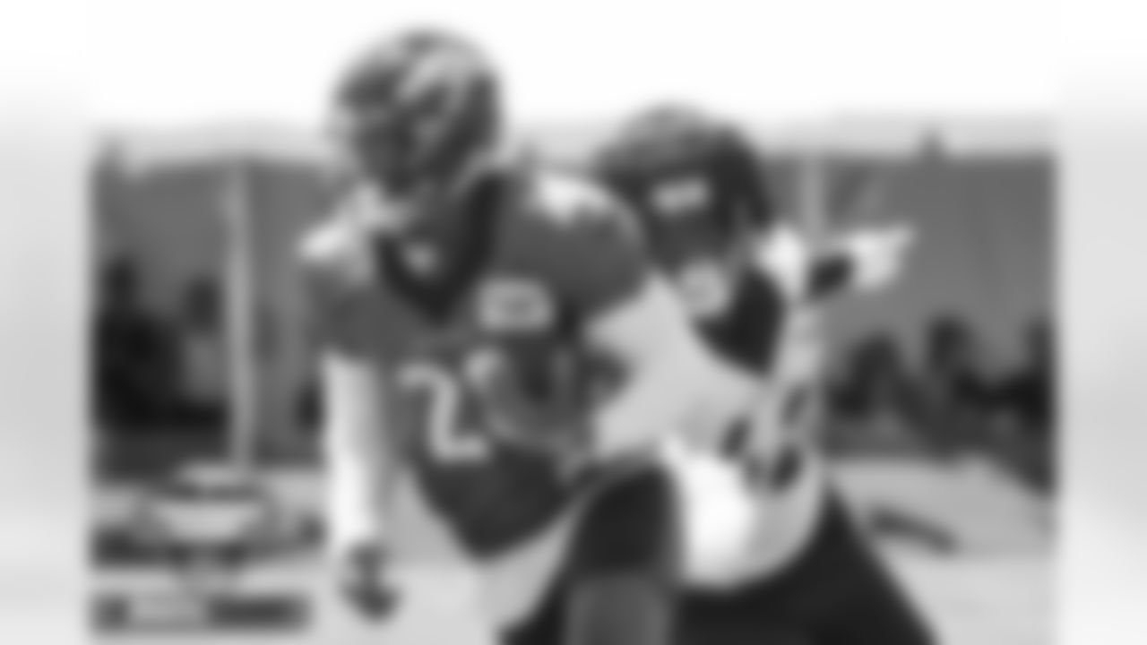 Nik Bonitto pursues Damarea Crockett at practice on Day 4 of training camp at UCHealth Training Center in Englewood, Colorado on July 30, 2022. (Photo by Ben Swanson)