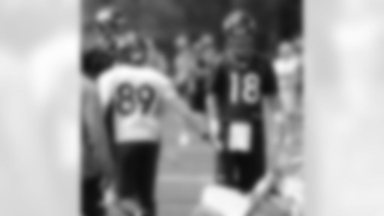 QB Peyton Manning high-fives WR Greg Orton after a completion.