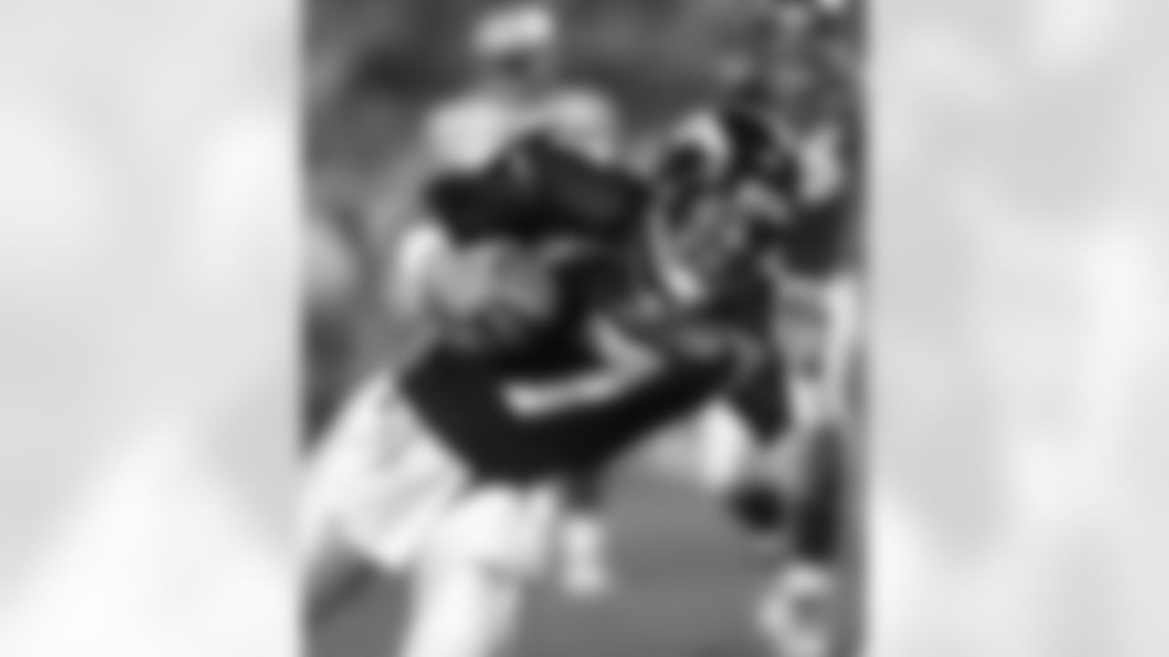 John Elway dives to pick up a crucial first down in the third quarter of the Broncos' 31-24 victory over the Packers in Super Bowl XXXII. It was the first Super Bowl championship in Broncos history, and in Elway's career.