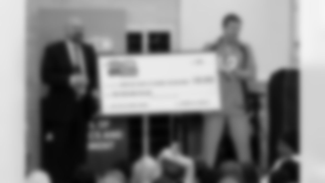 A $10,000 grant was presented to Montclair School of Academics & Enrichment on behalf of the Broncos, the NFL and Comcast. Comcast Vice President of Sales and Marketing David Tashjian is pictured on the left.