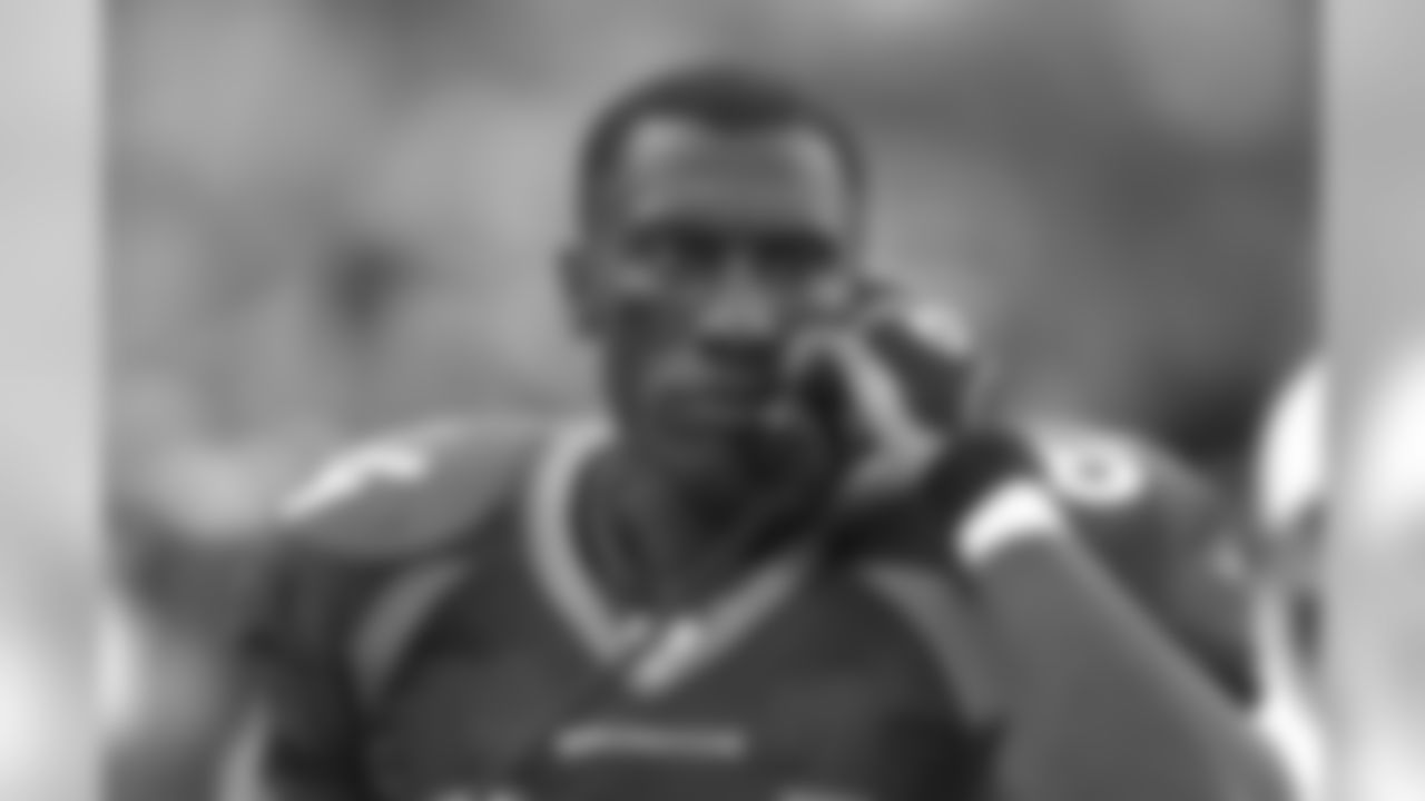 Shannon Sharpe talks with coaches up in the booth during a game against the San Francisco 49ers at INVESCO Field at Mile High in Denver, CO on August 19, 2002.