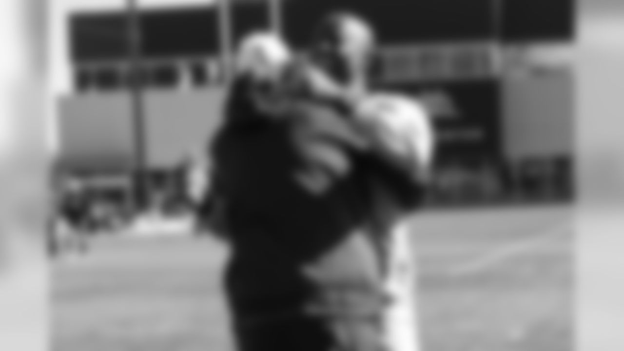 Defensive Coordinator Ed Donatell greets Brandon Lloyd as Broncos alumni watch the team's walkthrough and meet with current players and coaches afterward on October 12, 2019. (Photo by Ben Swanson)