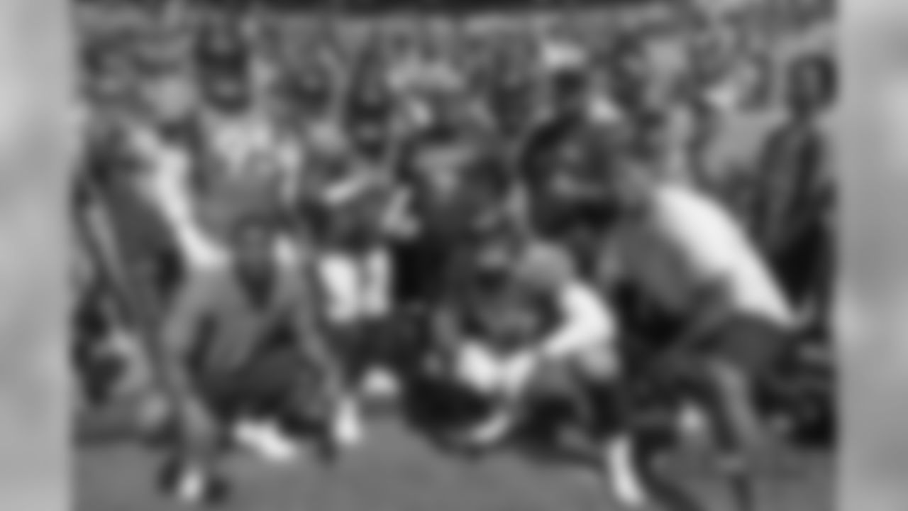 The defensive line group Ñ defensive end Derek Wolfe (95), defensive end Shelby Harris (96), defensive end Zach Kerr (92), nose tackle Domata Peko Sr. (94), nose tackle Kyle Peko (90), defensive end DeMarcus Walker (57) and defensive end Adam Gotsis (99) Ñ take a group photo with Peko Sr.'s father (center) before the Broncos' Week 1 game against the Seattle Seahawks at Broncos Stadium at Mile High on September 9, 2018.