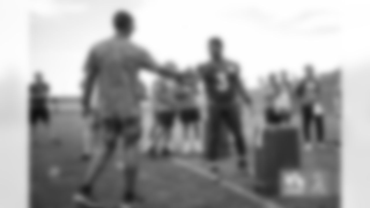 Russell Wilson conducts a competition with military members trying to hit the crossbar with a football during a USAA Salute to Service meet-and-greet session after practice at UCHealth Training Center in Englewood, Colorado on August 25, 2022. (Photo by Ben Swanson)