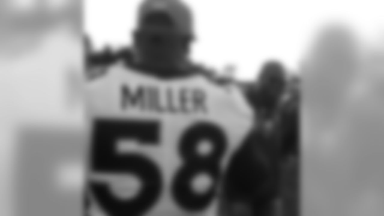 Von Miller greets Champ Bailey before the Broncos' preseason matchup with the Falcons in the Pro Football Hall of Fame Game on August 1, 2019 at Tom Benson Hall of Fame Stadium.