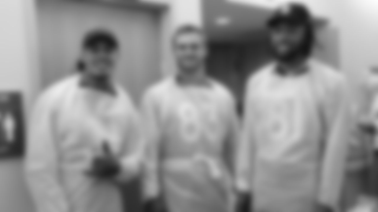 Justin Simmons, Andrew Beck and Tim Patrick 'gowned up' to visit a veteran who is receiving medical care through the Veterans Affairs health care system on November 19, 2019. (Photo by Emily Simanskis)