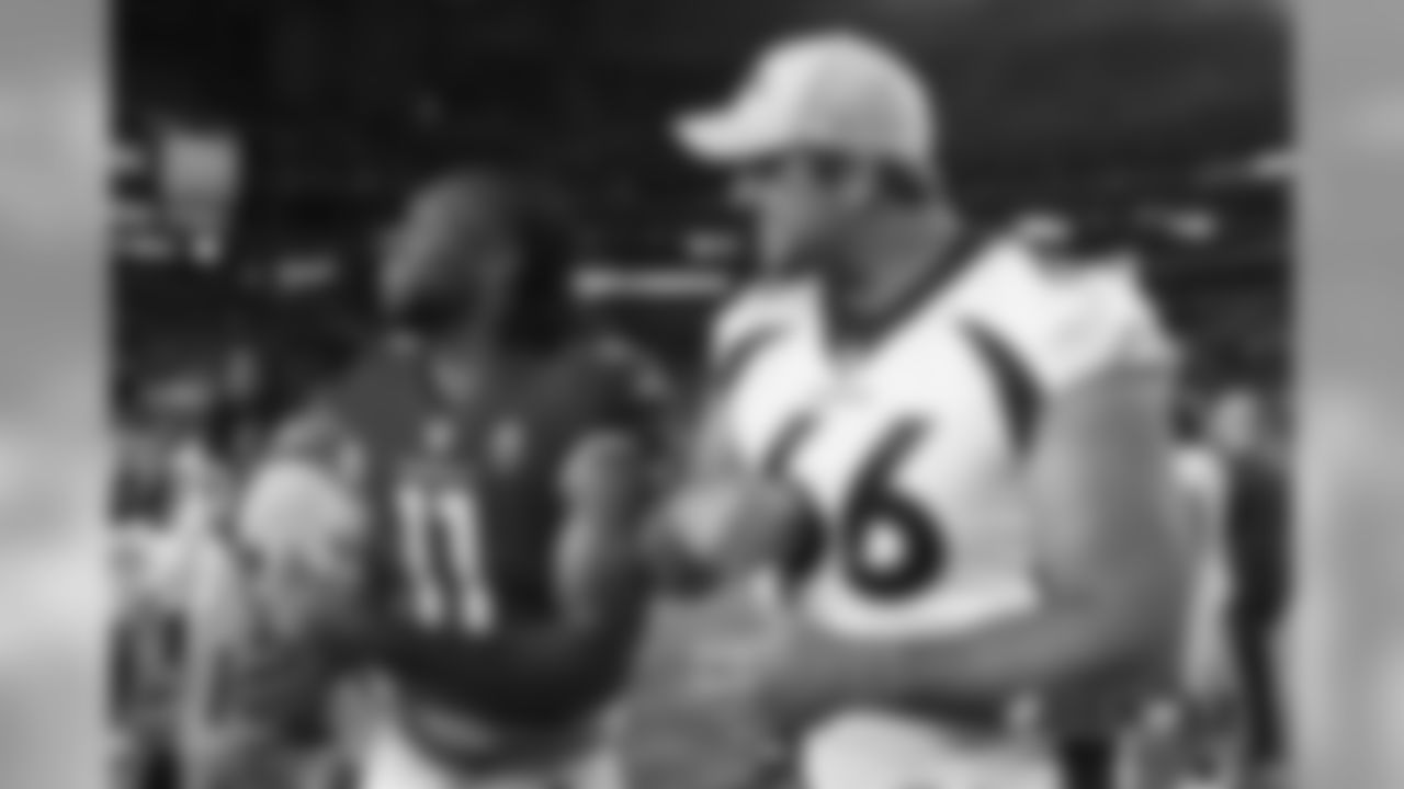 Jared Veldheer and his former Cardinals teammate Larry Fitzgerald break out in laughter after the Broncos' preseason game against the Arizona Cardinals on August 30, 2018.