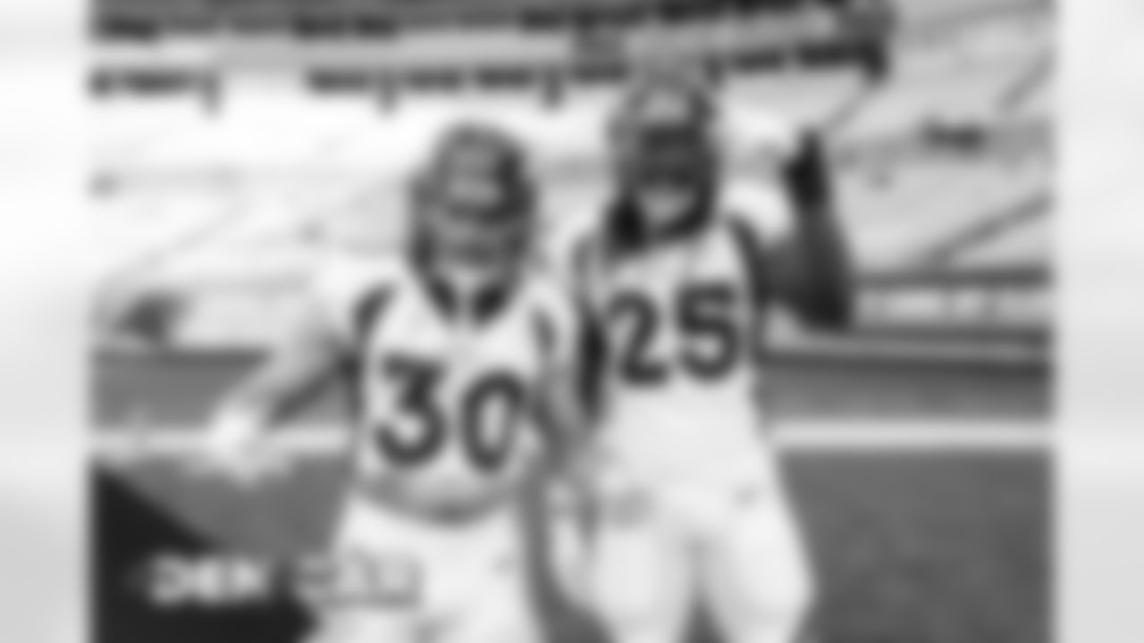Phillip Lindsay and Melvin Gordon III during pregame warmups before the Broncos' Week 14 game against the Carolina Panthers at Bank of America Stadium in Charlotte, North Carolina. (Photo by Gabriel Christus)